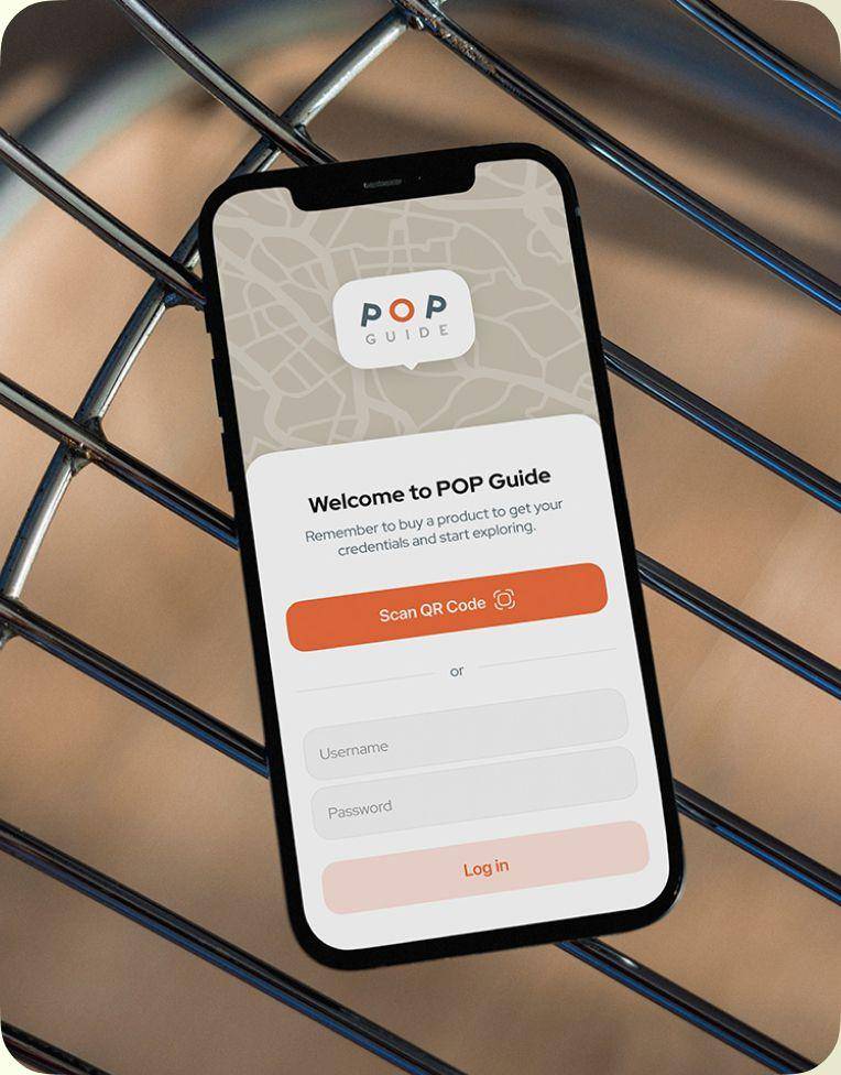 Smartphone showing the POPGuide welcome screen with QR code and login