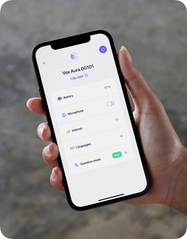 A hand holding a phone with the Vox App