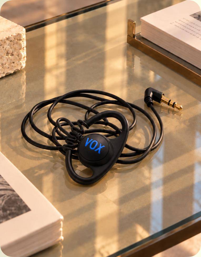 Vox over-ear earphones on a glass table