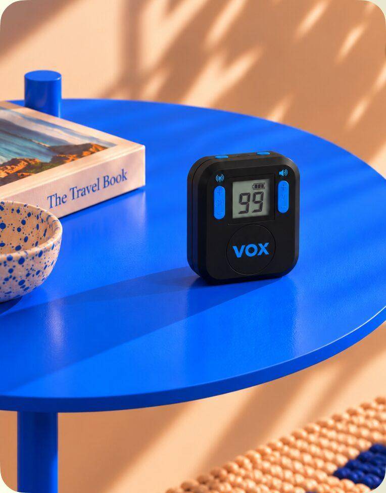 VDR Micro receiver on a blue table next to a travel book