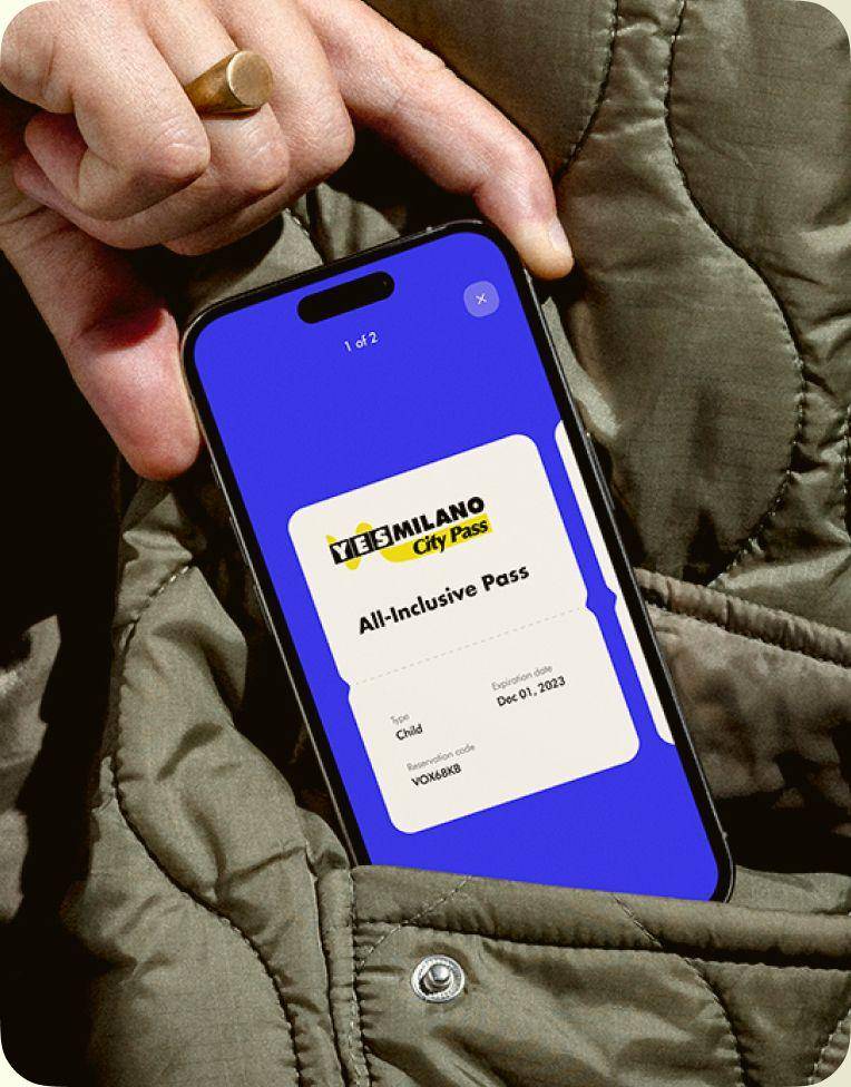 Hand pulling a smartphone with the YesMilano city pass out of a jacket pocket
