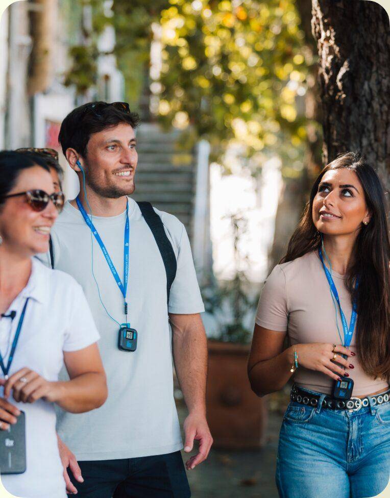 A group of visitors wearing Vox receivers on a walking tour